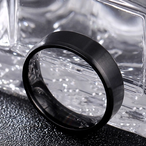 Macro shot of 8mm black matte titanium steel ring with double beveled edges and brushed finish