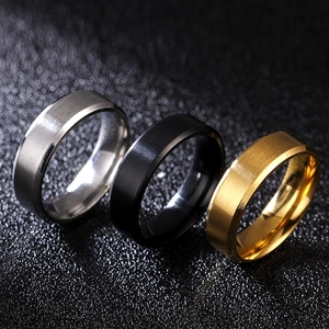Macro detail of beveled edges on silver black and gold brushed titanium steel rings