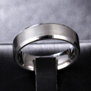 Macro shot of brushed titanium steel ring with double beveled mirror polished edges