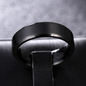 Macro shot of 8mm black brushed titanium steel ring with polished beveled edges for men