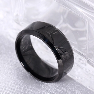Close-up of 8mm black titanium steel ring with double beveled edges and polished finish