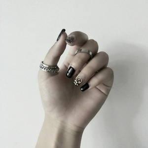 Close-up of a silver stainless steel chunky chain ring and a smooth polished band ring