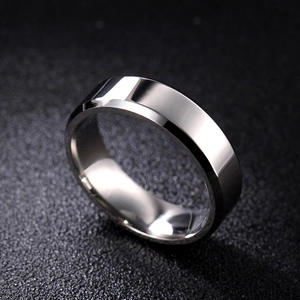 Macro shot of 8mm double-beveled 316 titanium steel ring with polished silver finish