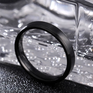 Macro view of matte black tungsten steel ring with brushed finish and beveled edges