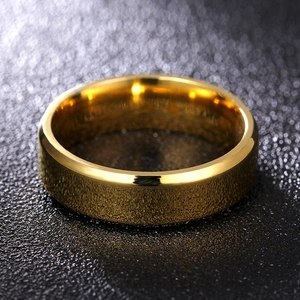 Macro detail of 8mm gold titanium ring with brushed texture and polished beveled edges