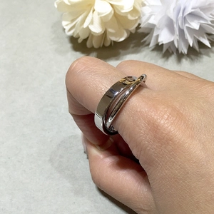 Detailed view of interconnected stainless steel wedding rings with high-polished silver finish