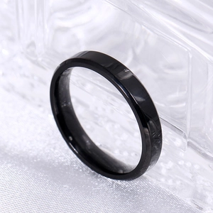 Macro side view of a black 8mm polished bevel edge titanium steel ring for men