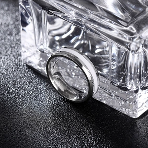 Detailansicht eines 6mm Edelstahlrings mit weißer Emaille-Einlage auf einem Glasträger