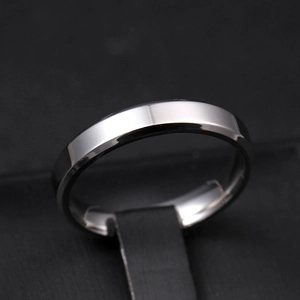 Macro view of 4mm beveled edge titanium steel ring with polished silver finish