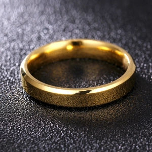 Macro detail of 8mm gold titanium ring with double beveled edges and polished finish