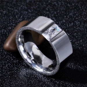 Polished 8mm stainless steel ring with a rectangular clear zircon stone on a pebble