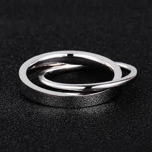 Macro detail of intertwined steel rings with contrast polished and frosted textures
