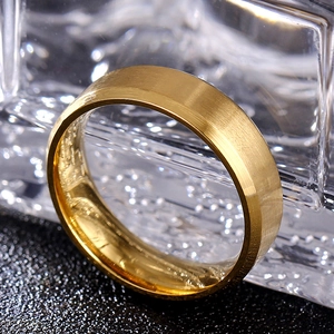 Macro shot of 8mm gold brushed steel ring with beveled edges and polished interior