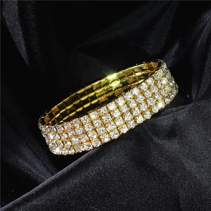Macro shot of 4-row sparkling crystal rhinestones set in a luxurious gold metal base