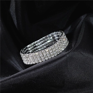 Detailed macro view of a 4-row crystal elastic bridal bracelet on black satin