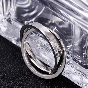 Close-up of polished silver-tone double ring with overlapping geometric design