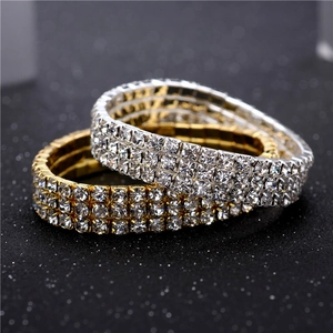 Close-up of triple-row rhinestone elastic bangles in gold and silver finish with sparkling stones