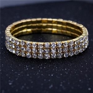 Detail of three-row crystal stretch bracelet with gold-plated base and sparkling rhinestones