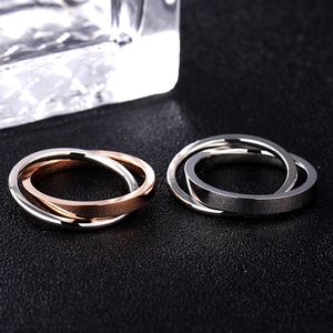 Macro shot of interlocking double bands in polished silver and rose gold steel