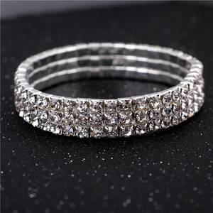 Macro view of a three-row elastic crystal bracelet with silver base and clear rhinestones