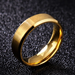 Macro detail of 8mm gold brushed stainless steel ring with polished beveled edges