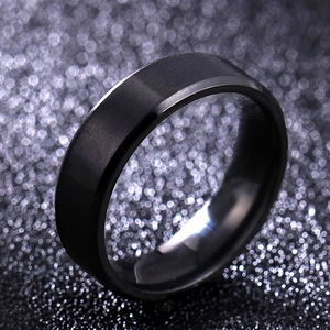 Detail of 8mm black titanium steel ring showing matte brushed finish and polished beveled edges