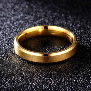 Detail of 8mm gold titanium ring showing brushed surface and polished beveled edges