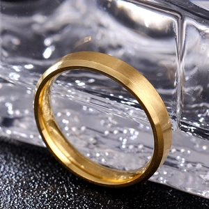Macro detail of 8mm gold ring showing brushed matte finish and polished beveled edges