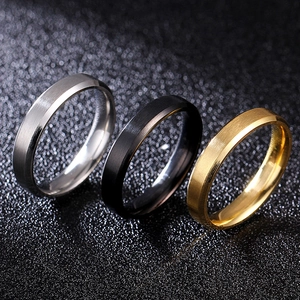 Close-up of 8mm beveled edge brushed metal rings in silver, black, and gold colors