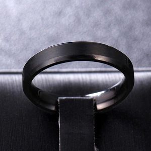 Macro shot of 8mm black titanium ring with brushed matte finish and polished beveled edges