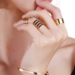Polished gold 10mm wide flat ring and chain jewelry set shown on a model hand