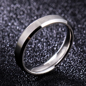 Macro shot of 8mm silver titanium steel ring with brushed surface and polished beveled edges