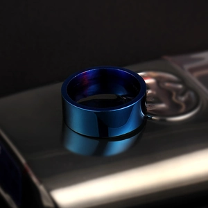 Macro detail of 8mm polished navy blue stainless steel ring with flat edge finish