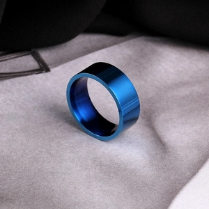 Macro shot of 8mm blue polished titanium steel ring with a smooth mirror finish