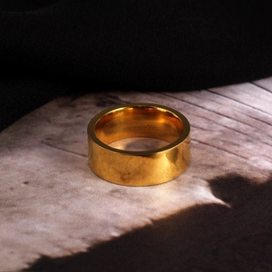 Macro shot of 8mm wide gold titanium steel ring with polished mirror finish
