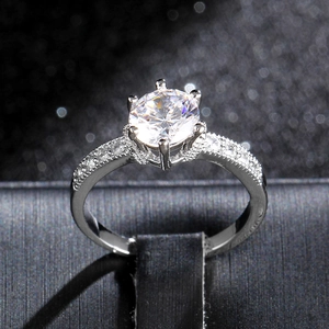 Classic six-prong zircon ring with micro-paved side diamonds and milgrain edges
