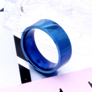 Macro detail of 8mm blue stainless steel flat band ring with polished metallic finish