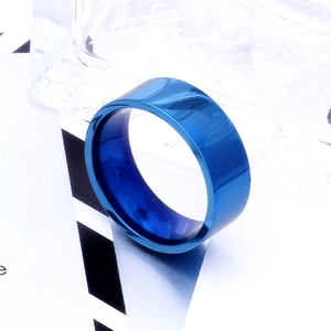 Macro shot of 8mm deep blue polished stainless steel ring with a smooth mirror finish