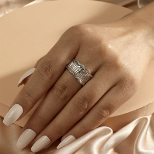 Irregular textured wide silver ring with zircon detailing on a minimalist background
