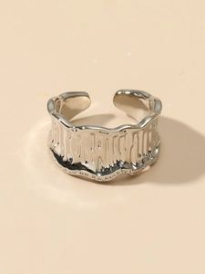 Detailed view of the irregular lava-like texture and silver finish on this adjustable ring