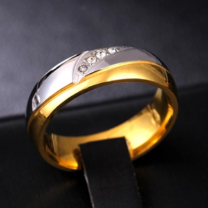 Détail macro d'une bague bicolore en acier inoxydable avec courbe en S et zircons