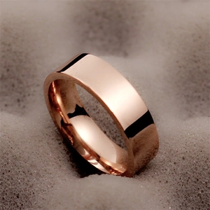 Detail of 6mm rose gold titanium steel ring with high-polished mirror finish surface