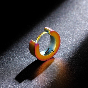 Detail macro of iridescent rainbow titanium steel huggie earring with matte texture