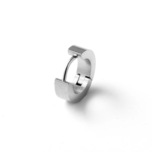 Macro shot of silver huggie earring with brushed metal finish and mechanical hinge