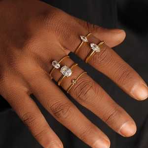 Macro shot of 18K gold plated stackable rings set with diverse zircon stone cuts on hand