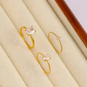 Detail shot of 18K gold plated stainless steel rings with zircon stones on velvet