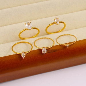 Detail of five 18K gold plated stainless steel rings set with sparkling zircon stones