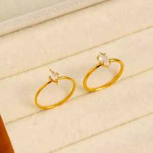 Close-up of gold 18K plated rings with marquise-cut zircons on a velvet jewelry box