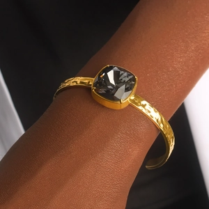 18K gold plated stainless steel open bangle with faceted square dark grey crystal