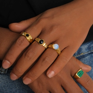 French vintage gold ring set with black onyx and malachite worn on a model's hand